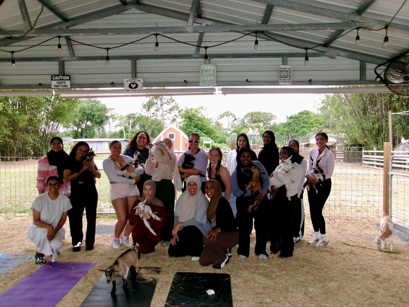 Ivys posing together under a farm pavilion at a Studio Ivayah gathering